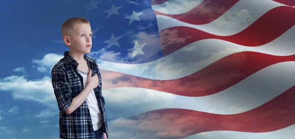 Proud Patriotic kid looks at American flag — Stock Photo, Image