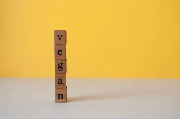 vegan word on a green yellow background