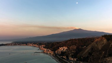 Mount Etna and the Giardini Naxos coastline at dawn clipart