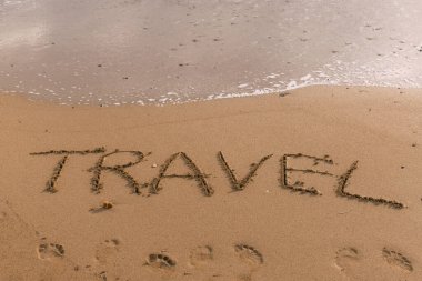 summer beach with travel lettering on sand near sea  clipart