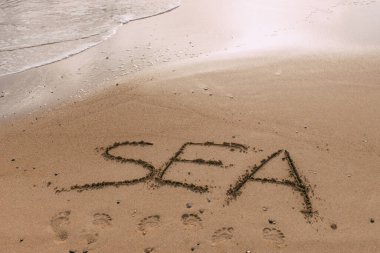 summer beach with sea lettering on sand  clipart