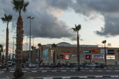 LIMASSOL, CYPRUS - MARCH 31, 2020: my mall limassol shopping centre near palm trees  clipart