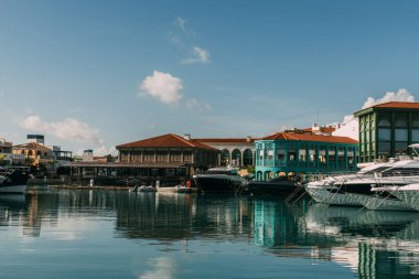 sunshine on buildings and docked yachts in mediterranean sea clipart