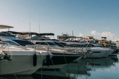 sunshine on docked modern yachts in mediterranean sea clipart