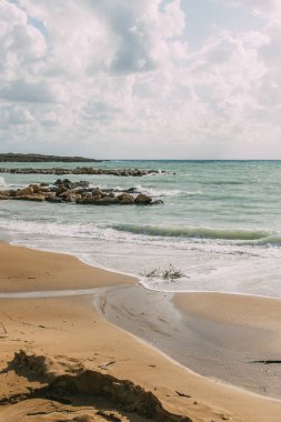coastline with sandy beach near mediterranean sea against blue sky clipart