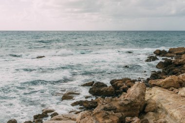 coastline of mediterranean sea against sky with clouds in cyprus clipart