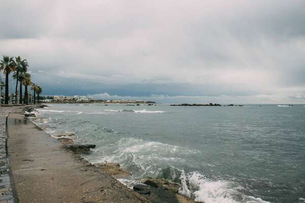 splash of water in mediterranean sea near shore with palm trees