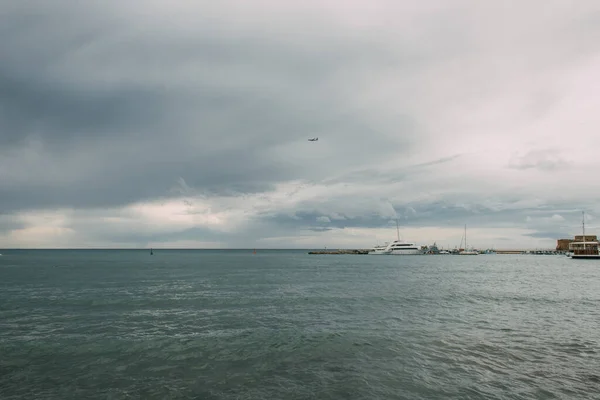 ships in mediterranean sea against sky with clouds 