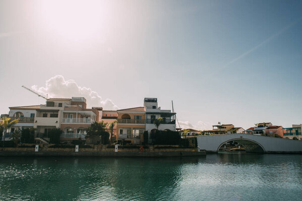 sunlight on houses near mediterranean sea against blue sky