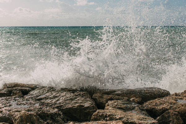 Splash of water from sea on wet rocks
 