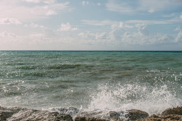 splash of water from mediterranean sea on wet rocks 