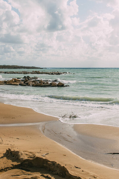 coastline with sandy beach near mediterranean sea against blue sky