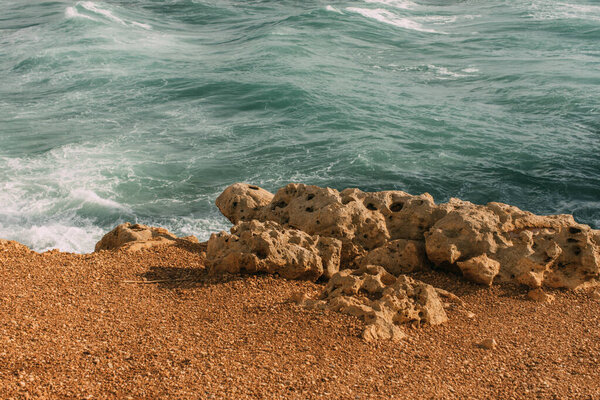 sunshine on stones near mediterranean sea 