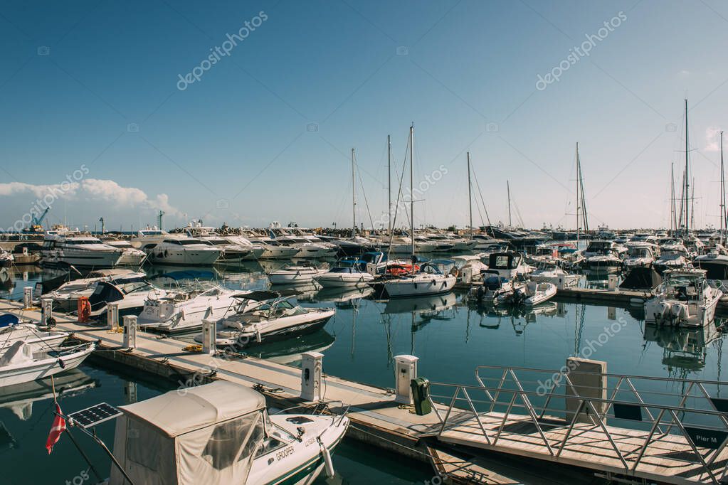Sunshine on docked yachts in port of mediterranean sea