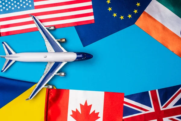Top View Toy Plane Flags Countries Blue Background — Stock Photo, Image