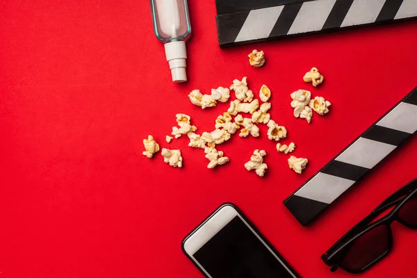 Top View Smartphone Clapperboard Popcorn Hand Sanitizer Red Background — Stock Photo, Image