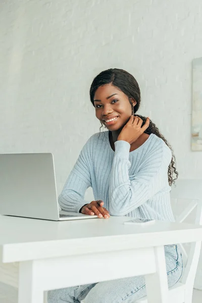 Feliz Afroamericano Freelancer Sonriendo Cámara Mientras Está Sentado Cerca Computadora —  Fotos de Stock