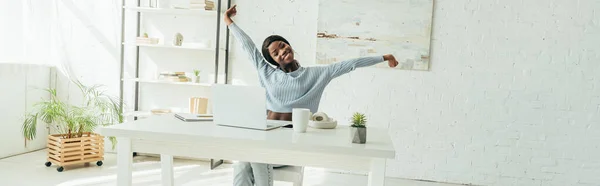 Horizontal Crop Happy African American Freelancer Stretching While Sitting Table — Stock Photo, Image