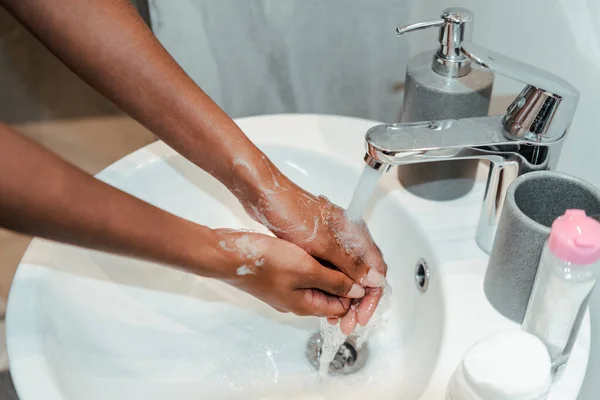 アフリカ系アメリカ人女性のバスルームで手を洗うの作物ビュー — ストック写真
