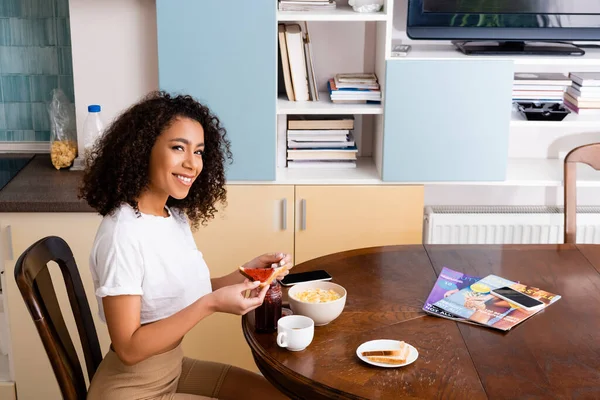 Happy Curly African American Woman Holding Spoon Toast Bread Corn — Stock Photo, Image