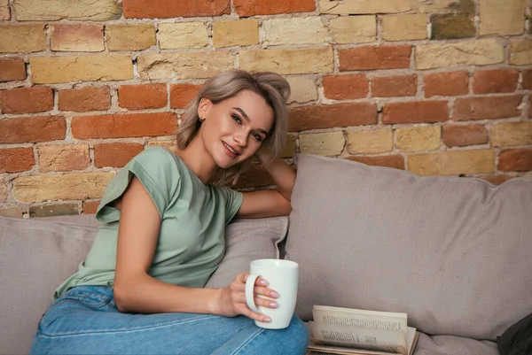 Happy Young Woman Smiling Camera While Sitting Sofa Cup Tea — Stock Photo, Image