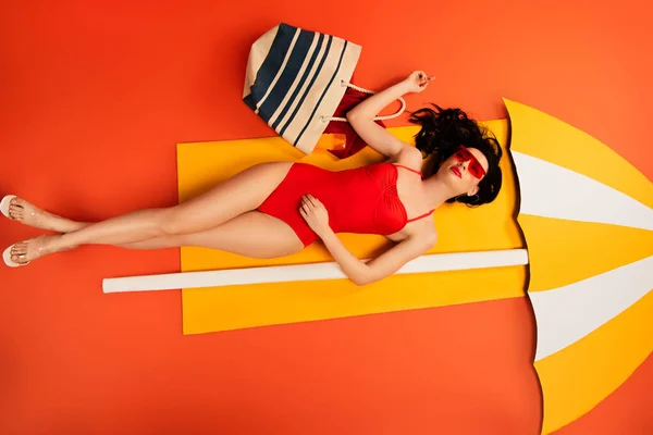 Top View Beautiful Girl Sunglasses Swimsuit Lying Bag Paper Umbrella — Stock Photo, Image
