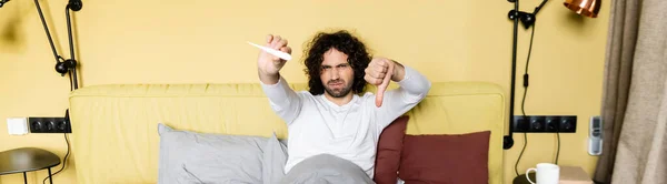 Horizontal Image Displeased Man Holding Thumb Looking Thermometer Bed — Stock Photo, Image