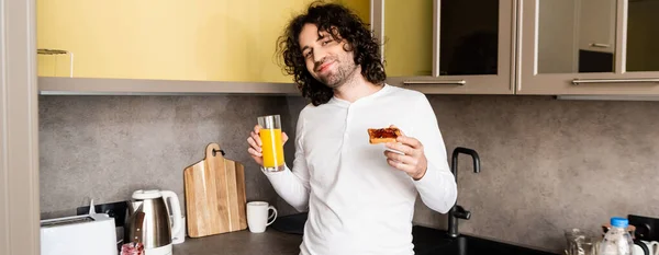 Horizontal Image Joyful Man Holding Orange Juice Toast Jam While — Stock Photo, Image