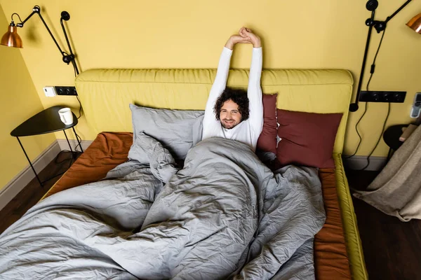 High Angle View Smiling Man Stretching While Lying Bed — Stock Photo, Image