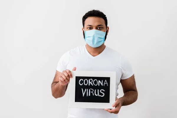 코로나 바이러스가 새겨진 칠판을 근처에 글자를 아프리카 미국인 의의학 마스크를 — 스톡 사진