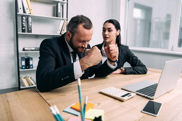 Stressed businessman and business colleague at workplace with laptop in office — Stock Photo