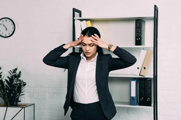 Portrait of stressed businesswoman standing in office — Stock Photo