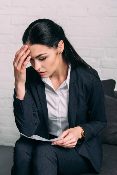 Portrait of tired businesswoman with papers in office — Stock Photo