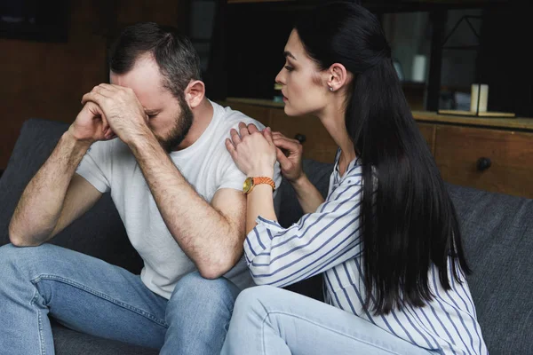 Young wife asking forgiveness from husband after quarrel at home — Stock Photo