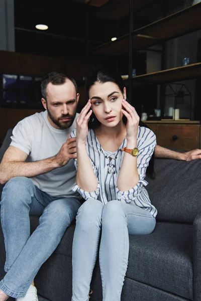 Young husband asking forgiveness from wife after quarrel at home — Stock Photo