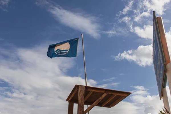 LIMASSOL, CYPRUS - MARCH 31, 2020: low angle view of blue flag as international award of beach excellence — Stock Photo