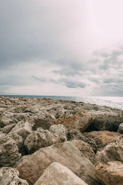 Rocas cerca del mar Mediterráneo contra el cielo con nubes - foto de stock