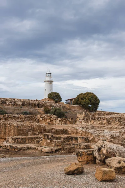 Ancient archaeological park with ruins and trees near lighthouse — Stock Photo