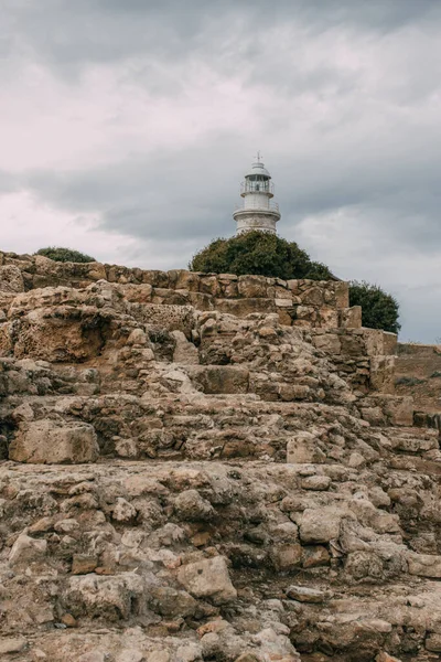 Ancient archaeological park with ruins and rocks near lighthouse — Stock Photo