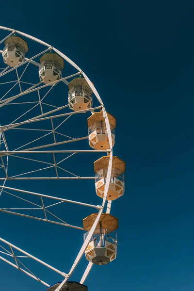 Солнце на металлическом колесе обозрения против голубого неба — стоковое фото