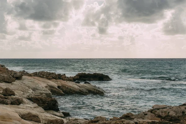 Coastline near mediterranean sea against grey sky with clouds — Stock Photo