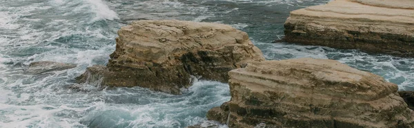 Panoramic shot of stones near water in mediterranean sea — Stock Photo