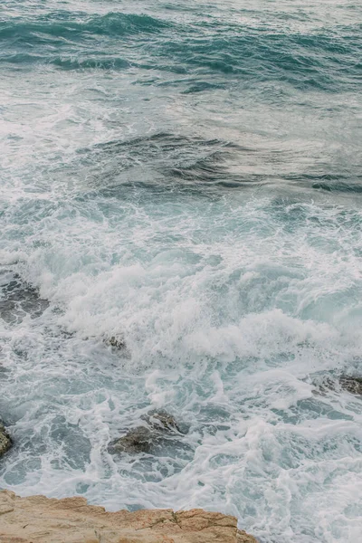 Mousse blanche dans l'eau bleue de la mer Méditerranée — Photo de stock