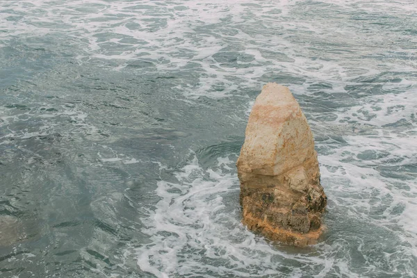 White foam near wet stone in water of mediterranean sea in cyprus — Stock Photo