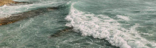 Panoramic shot of white foam in blue water of mediterranean sea — Stock Photo