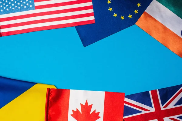 Top view of flags of countries on blue background — Stock Photo