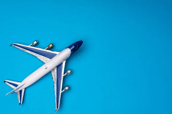 Top view of toy airplane on blue background with copy space — Stock Photo