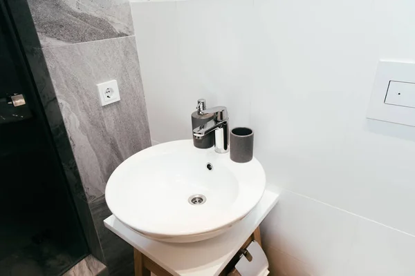 Modern interior of bathroom with white washbasin and soap dispenser — Stock Photo