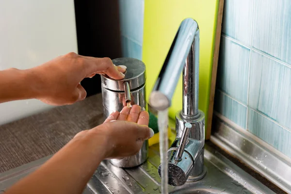 Cropped view of african american girl pouring liquid soap on hand — Stock Photo