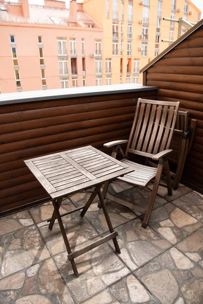 Wooden chair and table on modern balcony — Stock Photo